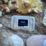SIBŌ Tone Card in its protective case on a sheepskin with crystals and dried flowers