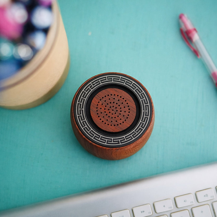 Top-down view of TŌNEM on a turquoise desk next to a keyboard